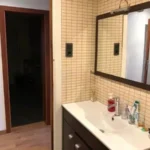 Fully furnished student apartment room in C/ de Muntaner 89 Barcelona with double bed, study desk, wardrobe, and natural light