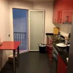 Fully furnished student apartment room in C/ de Muntaner 89 Barcelona with double bed, study desk, wardrobe, and natural light