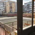 Fully furnished student apartment room in C/ de Muntaner 89 Barcelona with double bed, study desk, wardrobe, and natural light
