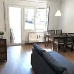 Fully furnished student apartment room in C/ de Muntaner 89 Barcelona with double bed, study desk, wardrobe, and natural light