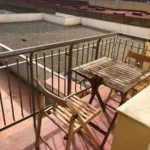 Fully furnished student apartment room in C/ de Muntaner 89 Barcelona with double bed, study desk, wardrobe, and natural light