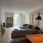 Bright student room in Eixample Barcelona with private bathroom, balcony, and double bed