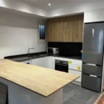 Bright student room in Eixample Barcelona with private bathroom, balcony, and double bed