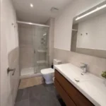 Bright student room in Eixample Barcelona with private bathroom, balcony, and double bed