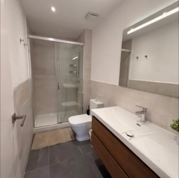Bright student room in Eixample Barcelona with private bathroom, balcony, and double bed