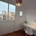 Bright student room in Eixample Barcelona with private bathroom, balcony, and double bed
