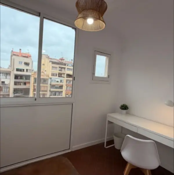 Bright student room in Eixample Barcelona with private bathroom, balcony, and double bed