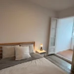 Bright student room in Eixample Barcelona with private bathroom, balcony, and double bed