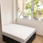 Furnished student room in Eixample Barcelona with private bathroom desk and built-in wardrobe