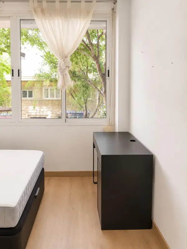 Furnished student room in Eixample Barcelona with private bathroom desk and built-in wardrobe