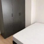 Furnished student room in Eixample Barcelona with private bathroom desk and built-in wardrobe