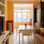 Spacious student room in Plaça Urquinaona Barcelona with double bed, study desk, and shared terrace