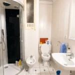 Spacious student room in Plaça Urquinaona Barcelona with double bed, study desk, and shared terrace