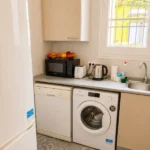 Spacious student room in Plaça Urquinaona Barcelona with double bed, study desk, and shared terrace