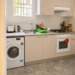 Spacious student room in Plaça Urquinaona Barcelona with double bed, study desk, and shared terrace