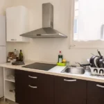 Spacious student room in Plaça Urquinaona Barcelona with double bed, study desk, and shared terrace