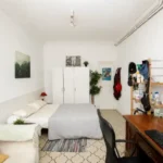 Spacious student room in Plaça Urquinaona Barcelona with double bed, study desk, and shared terrace